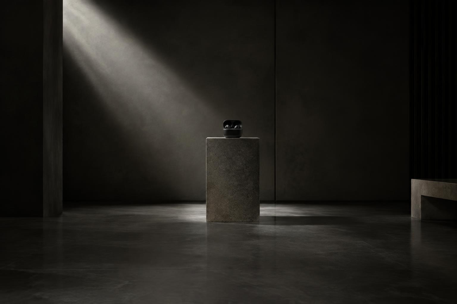 AURA ONE case displayed on a stone plinth in a concrete atelier